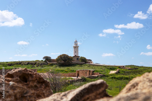 Historical Paphos lighthouse set in the middle of archaeological park in Paphos, Cyprus. View on Pafos landscape with beautiful white beacon and with clear sky