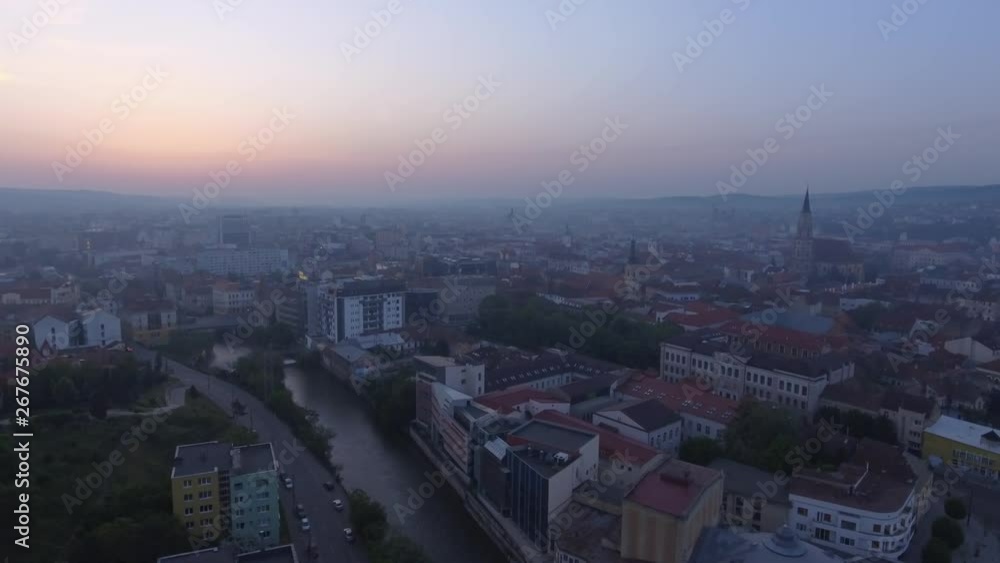 Aerial drone shot of a city and a river at sunrise Aerial drone shot of a city and a river at sunrise