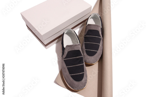 Soft leather slipons over beige and white background  photo