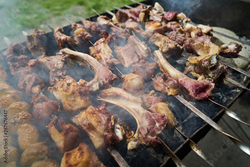 Grilled shish kebab with vegetables. BBQ grill with lamb meat and potatoes