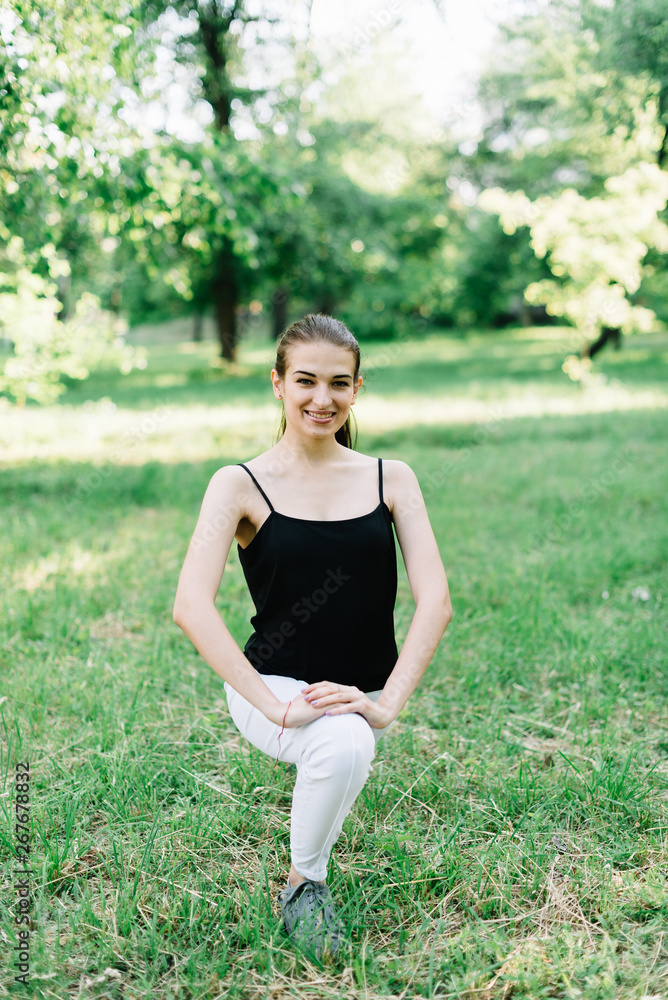 Young beautiful girl doing yoga outdoors in the park Young beautiful girl doing yoga outdoors in the park