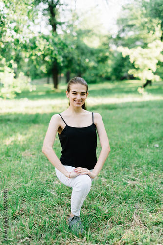 Young beautiful girl doing yoga outdoors in the park © prokop.photo
