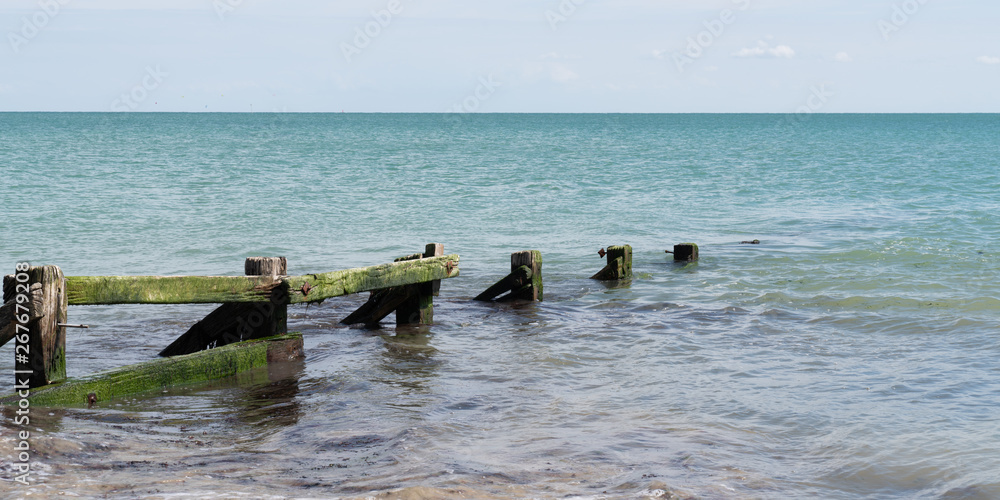 Sea beach and old wooden breakwater template web banner Sea beach and old wooden breakwater template web banner