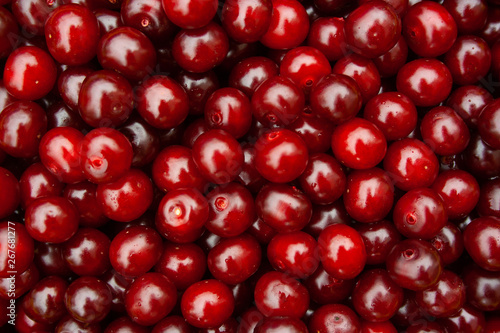 Heap of fresh red cherry with water drops. pile of ripe cherries background close up