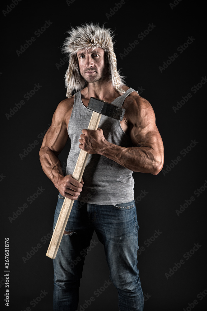 Athlete with sexy torso with sledge hammer. man worker with fit torso. male  hold sledge hammer. power and energy concept. bodybuilding. man worker in  winter hat. opportunity concept. mens power Stock Photo