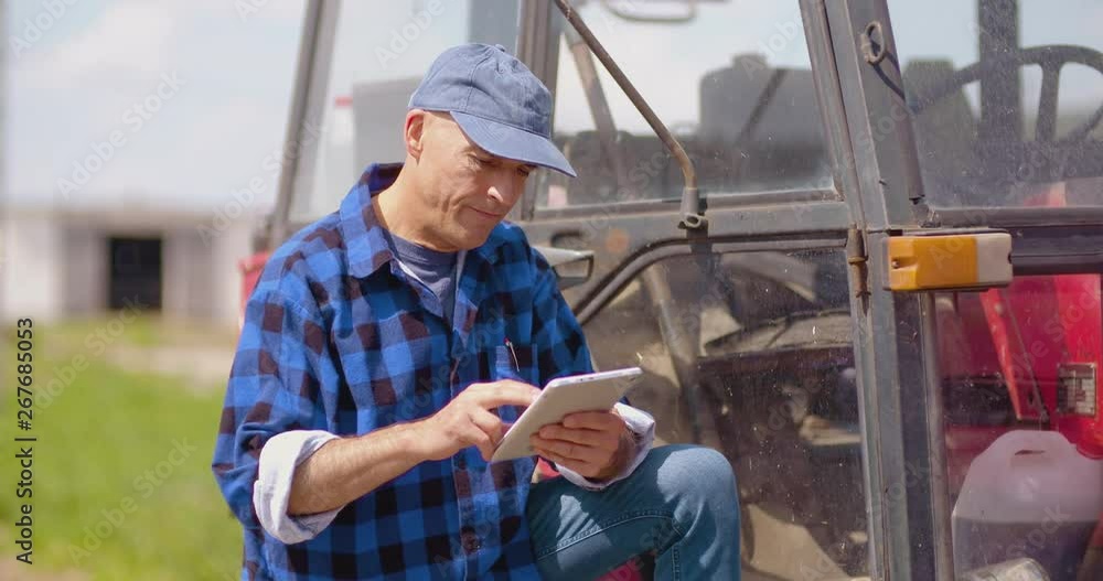Male researcher using digital tablet by machinery Male researcher using digital tablet by machinery