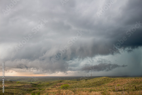 A wall cloud gathers under the base of a supercell storm in the great plains. © Dan Ross