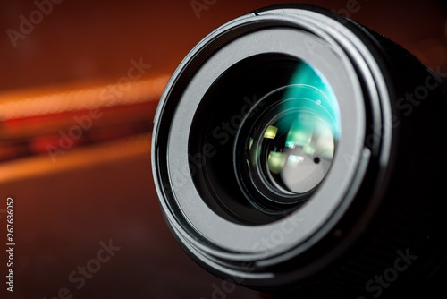 Camera lens close up on colorful blurred background
