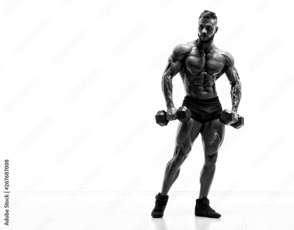 Handsome Young Body Builder Exercise With Dumbbells. Black and White Image