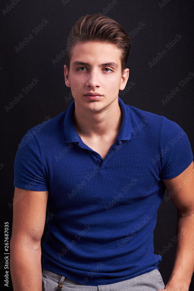 Elegant young handsome man posing on black background Elegant young handsome man posing on black background