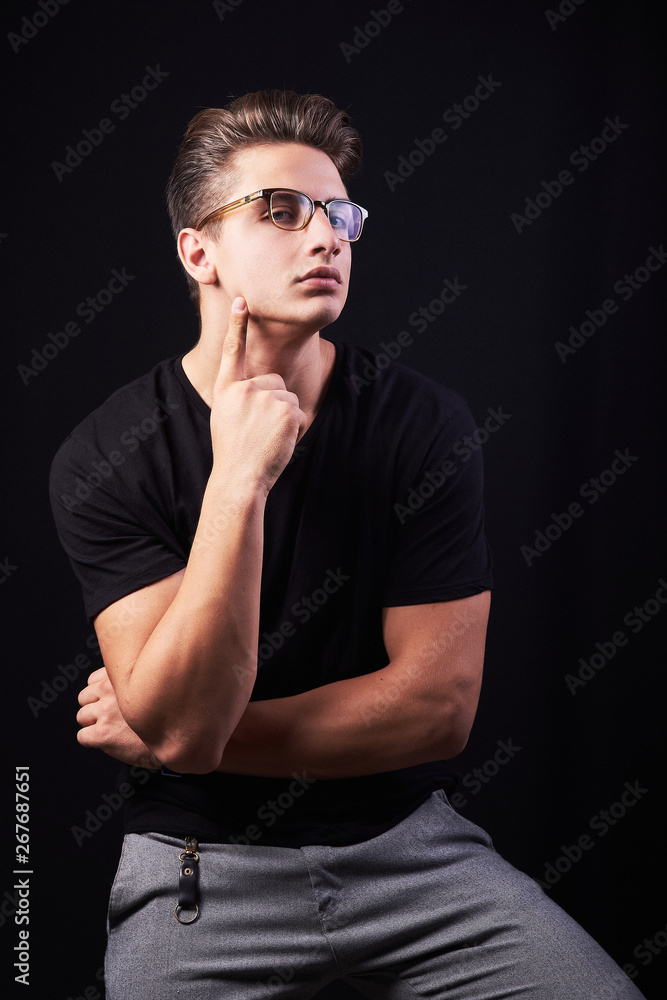 Portrait of elegant young handsome man isolated on black background Portrait of elegant young handsome man isolated on black background