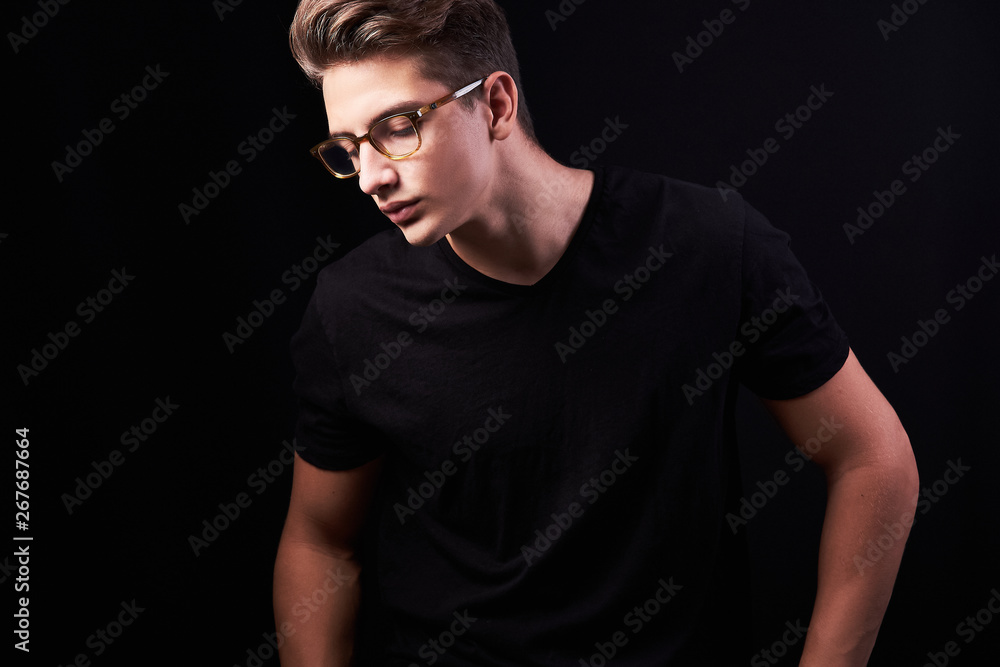 Portrait of elegant young handsome man isolated on black background