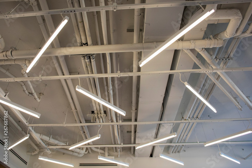 A unique display of lighting in the ceiling of a industrial building. 
