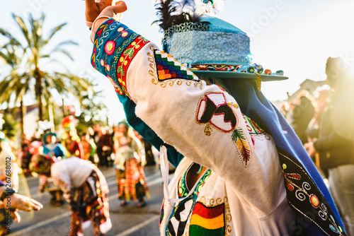 Valencia, Spain - February 16, 2019: Woman performing the Bolivian folk dance the Tinku dressed in folkloric and colorful traditional dress during the carnival of the Ruzafa district in Valencia. photo