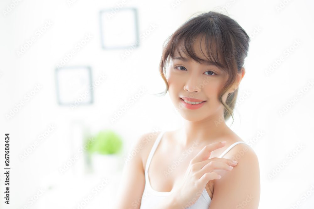 Beautiful young asian woman applying cream treatment for skin care touch on shoulder, asia girl with lotion spa and moisturizing health and wellness body part, lifestyle and beauty cosmetic concept. Beautiful young asian woman applying cream treatment for skin care touch on shoulder, asia girl with lotion spa and moisturizing health and wellness body part, lifestyle and beauty cosmetic concept.