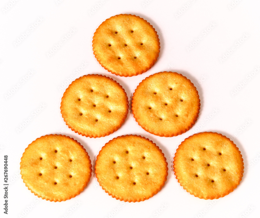 pyramid of six round crackers on white, in three rows, learning to count concept.