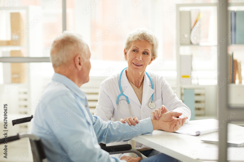 Portrait of female doctor checking pulse while consulting elderly man, copy space Portrait of female doctor checking pulse while consulting elderly man, copy space