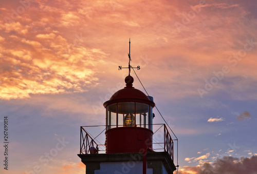 Lighthouse of Ponta do Altar on sunset sky background