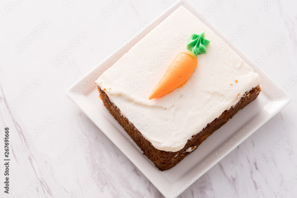Carrot cake slice with frosting carrot topper Carrot cake slice with frosting carrot topper