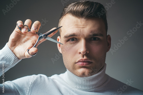 Barber glossy hairstyle hold steel scissors. Create your style. Macho confident barber cut hair. Barbershop service concept. Professional barber equipment. Cut hair. Man strict face hold scissors