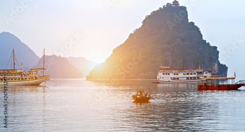 Cruise traditional ship wooden junk sailing Ha Long Bay, Vietnam UNESCO World Heritage Site.