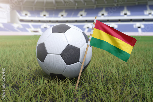 Bolivian flag in stadium field with soccer football