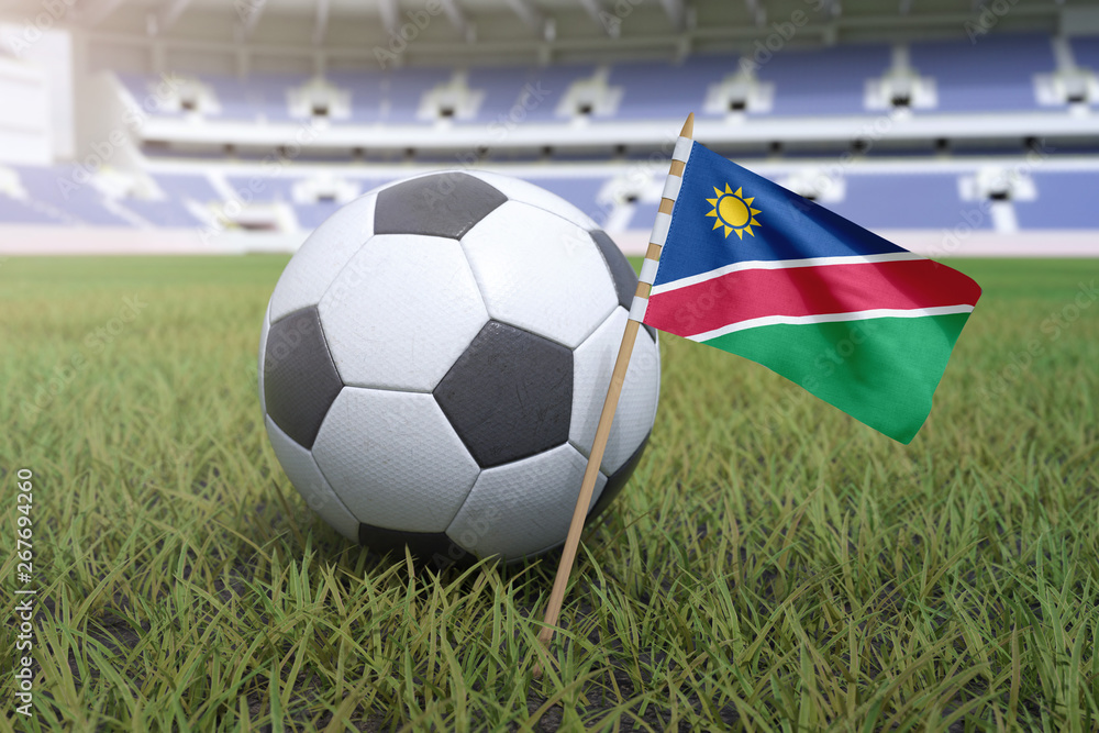 Fototapeta premium Namibia flag in stadium field with soccer football