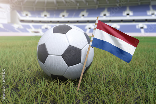 Netherlands flag in stadium field with soccer football