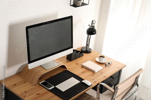 Stylish workplace interior with modern computer on table. Mockup for design © New Africa