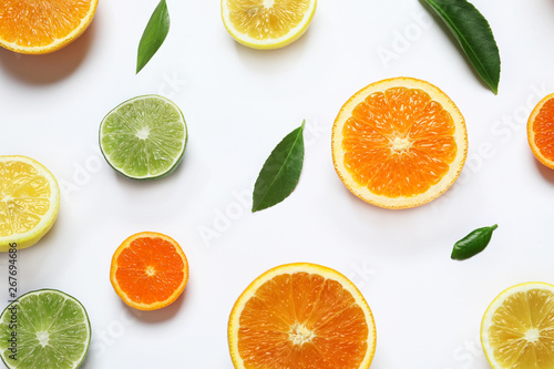 Different citrus fruits on white background, top view