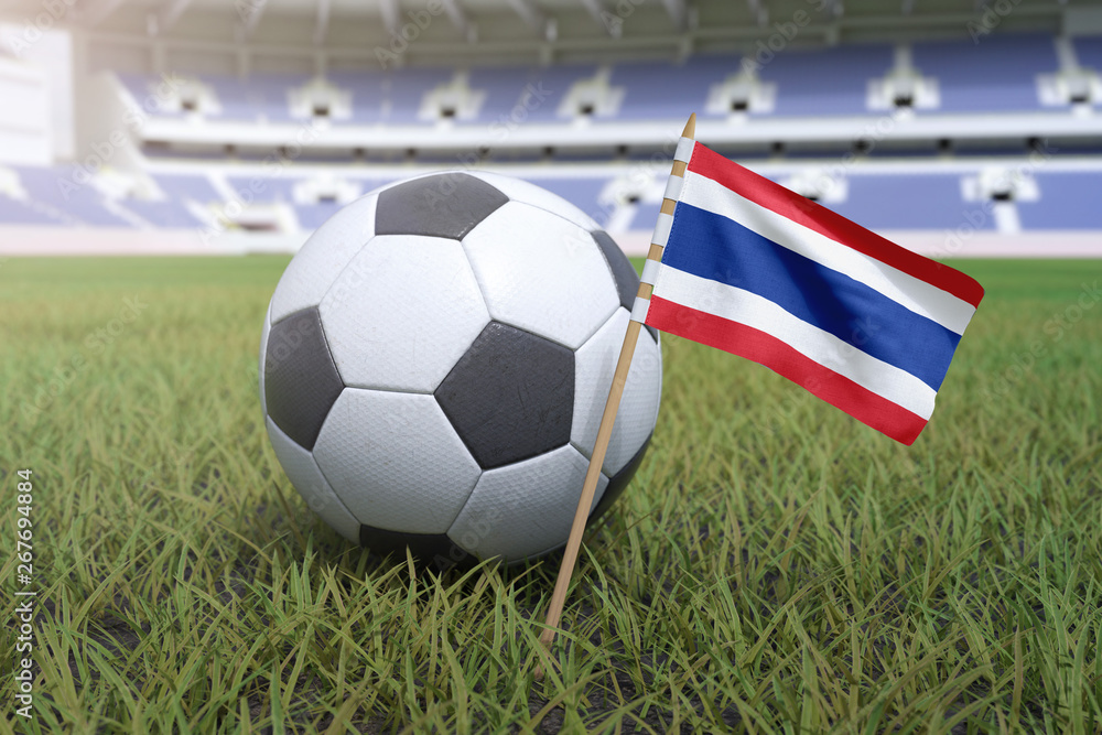 Fototapeta premium Thai flag in stadium field with soccer football
