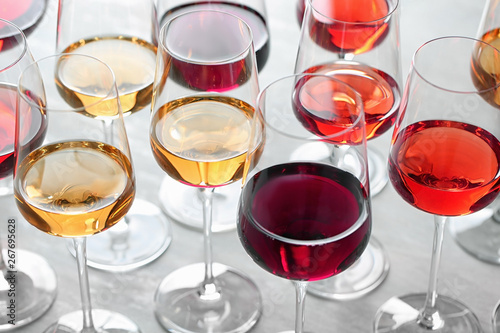 Group of glasses with different wines on light table