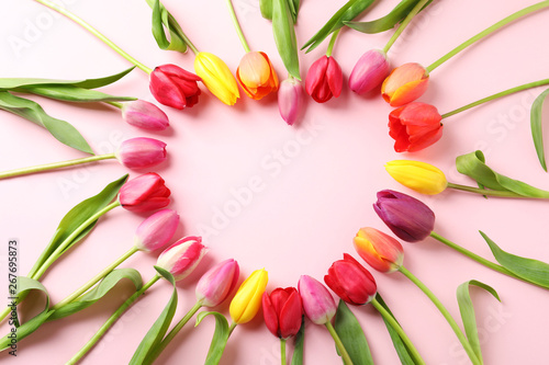 Heart made of beautiful tulip flowers on color background, flat lay. Space for text
