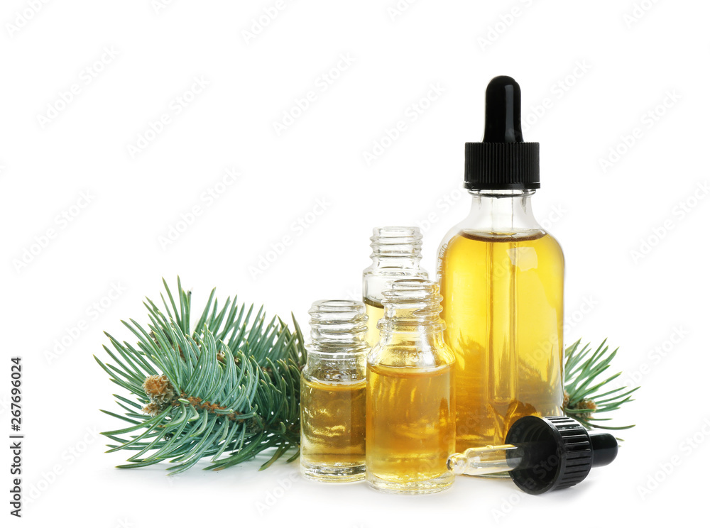 Different little bottles with essential oils and pine branch on white background Different little bottles with essential oils and pine branch on white background