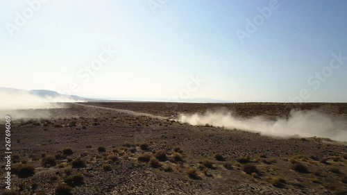 Low aerial shot tracking an off road vehicle during a desert race in Fallon, Nevada. photo