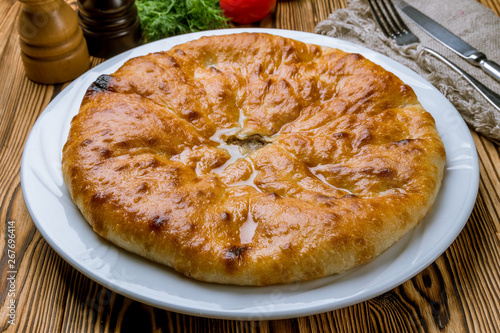 Ossetian pie with meat on white plate