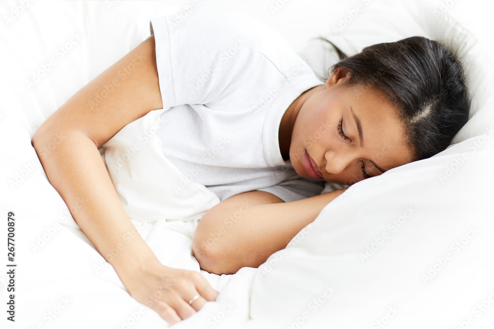 Portrait of beautiful Mixed-Race woman sleeping on white pillows, copy space Portrait of beautiful Mixed-Race woman sleeping on white pillows, copy space