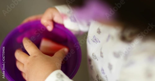 Father hands toddler girl strawberries and she happily walks away to enjoy the tastey treat. Shot in slowmotion 4k.mov