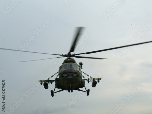 Large Russian military helicopter flying against the gray sky Russian air force