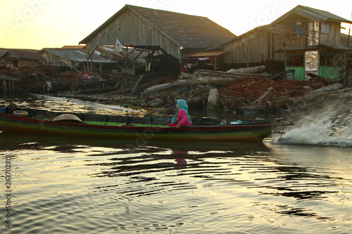 Citra Bahari Barito river floating market in the morning, full of gold from the sunrise in Banjarmasin / South Kalimantan - Indonesia, May 12, 2019 photo