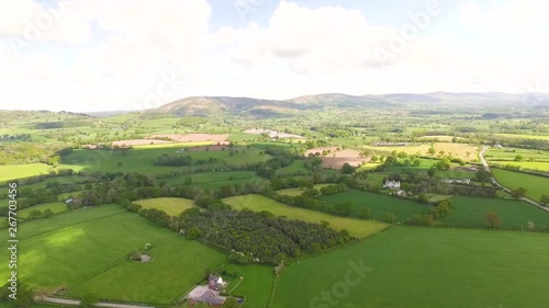 aerial view of agricultural farmland looking out towards hills in the distance. photo