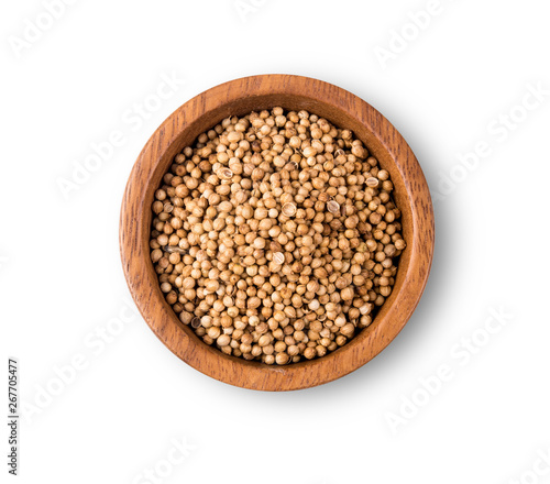 Dried coriander seeds top view on white background