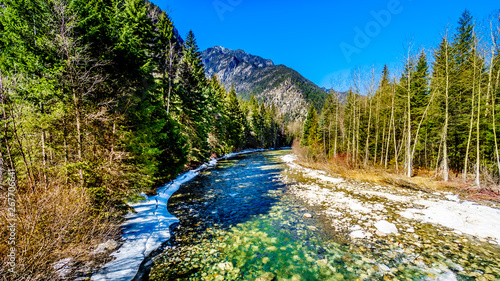 Fototapeta Naklejka Na Ścianę i Meble -  Partly frozen Cayoosh Creek which runs for the most part next to Highway 99, the Duffey Lake Road, between Pemberton and Lillooet in southern British Columbia, Canada