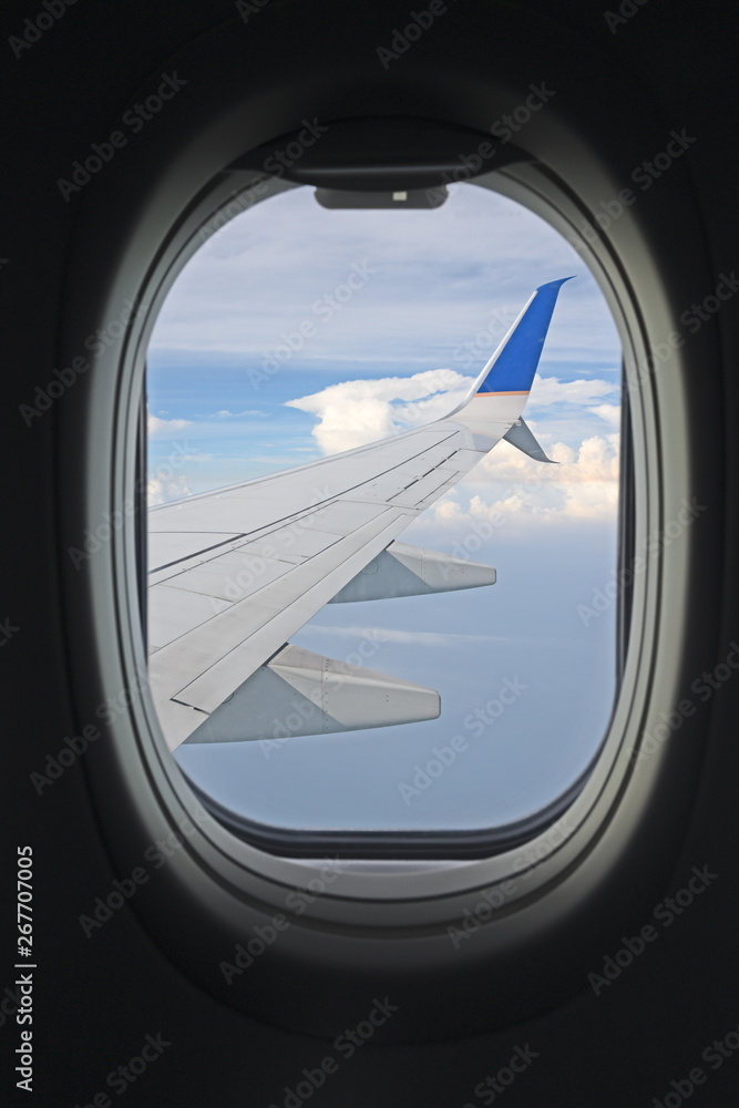 View of a wing from the airplane on the air with blue skies and some clouds View of a wing from the airplane on the air with blue skies and some clouds