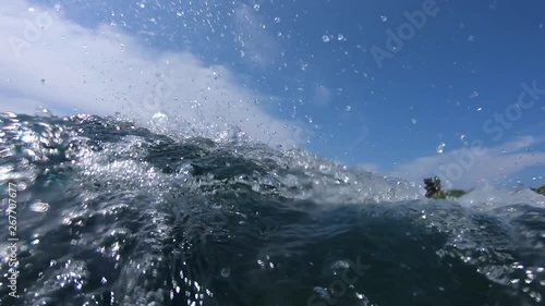 Young surfer rides the ocean wave at the Jailbreaks surf spot. Clip contains underwater view of the surfboard gliding on the wave