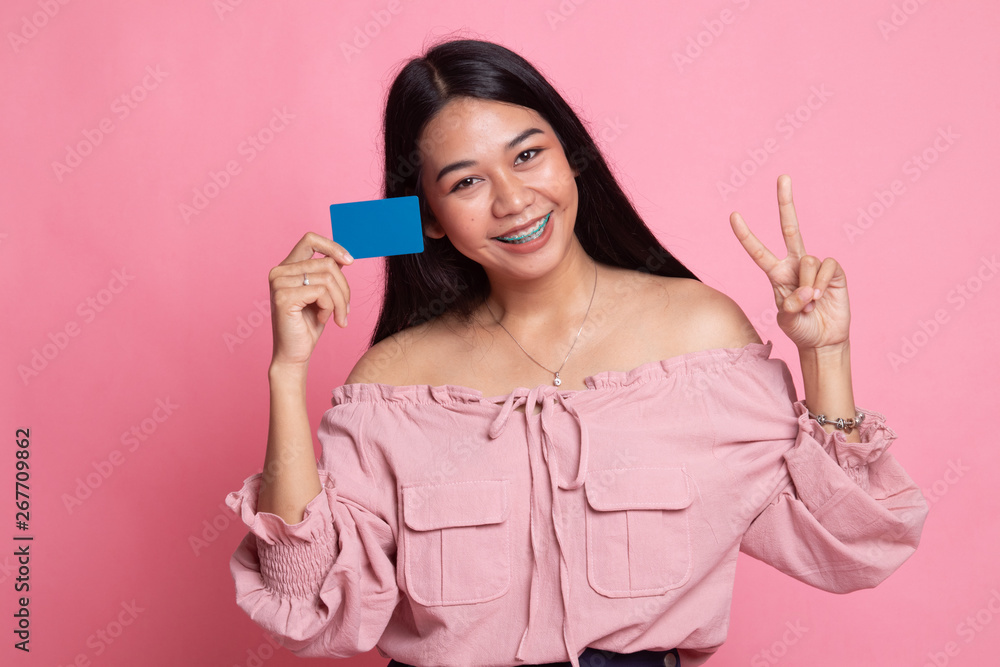 Young Asian woman show Victory with a blank card. Young Asian woman show Victory with a blank card.