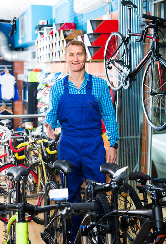 man in uniform working in bicycle shop .