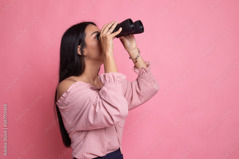 Young Asian woman with binoculars. Young Asian woman with binoculars.
