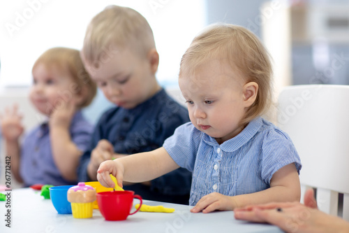 Group of babies kids engaged in handcrafts in nursery