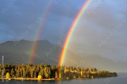 Bright beautiful real double rainbow in cloudy sky, Queenstown, New Zealand